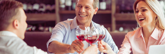 A couple toasts with the sommelier enjoying a rose wine.