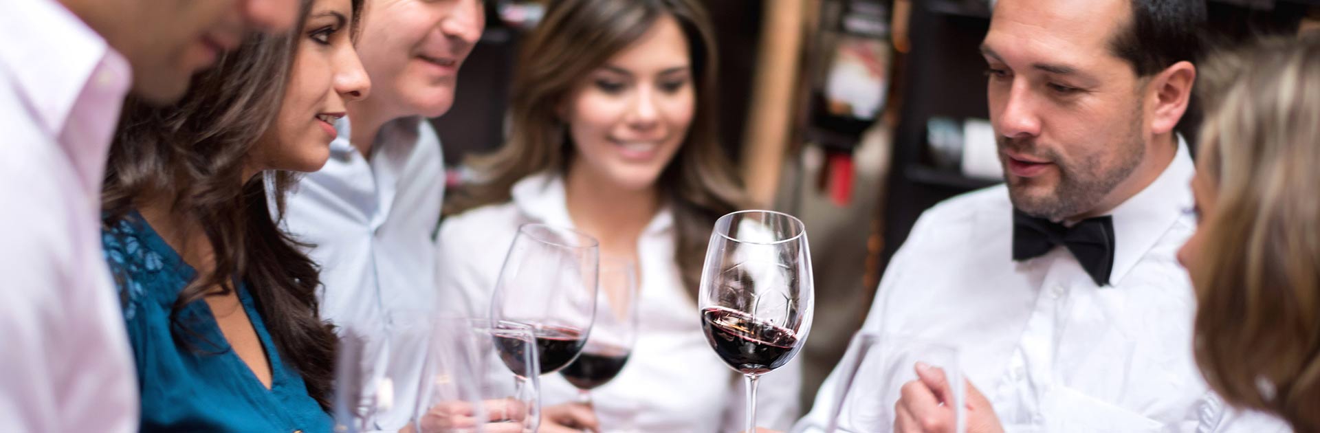 Young people enjoying a wine tasting event.