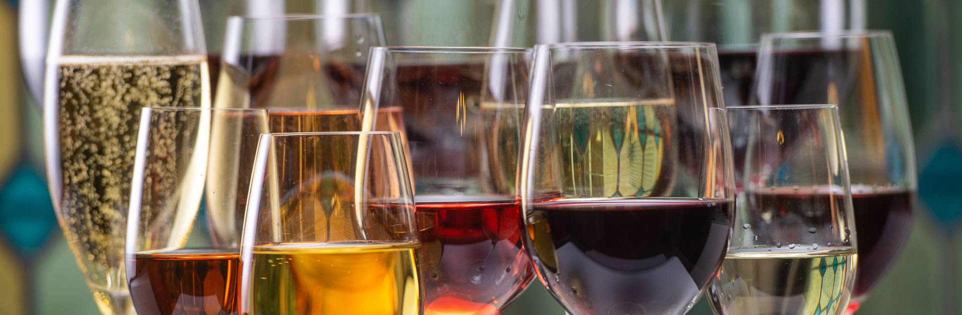 Multiple wine and champagne glasses lined up to represent the features of VinNOW